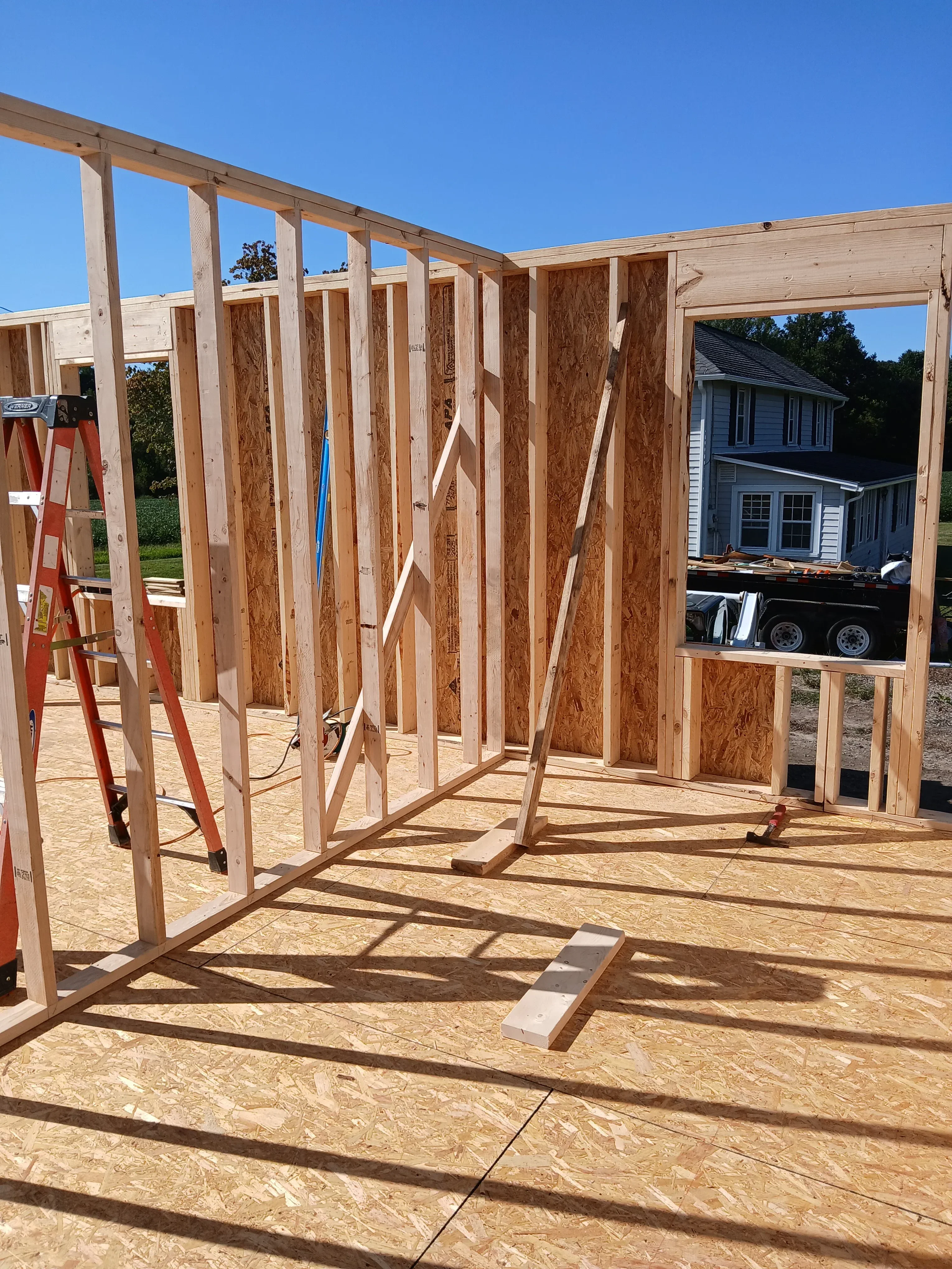 Wooden floor joists and beams with OSB sheathing on residential framing project