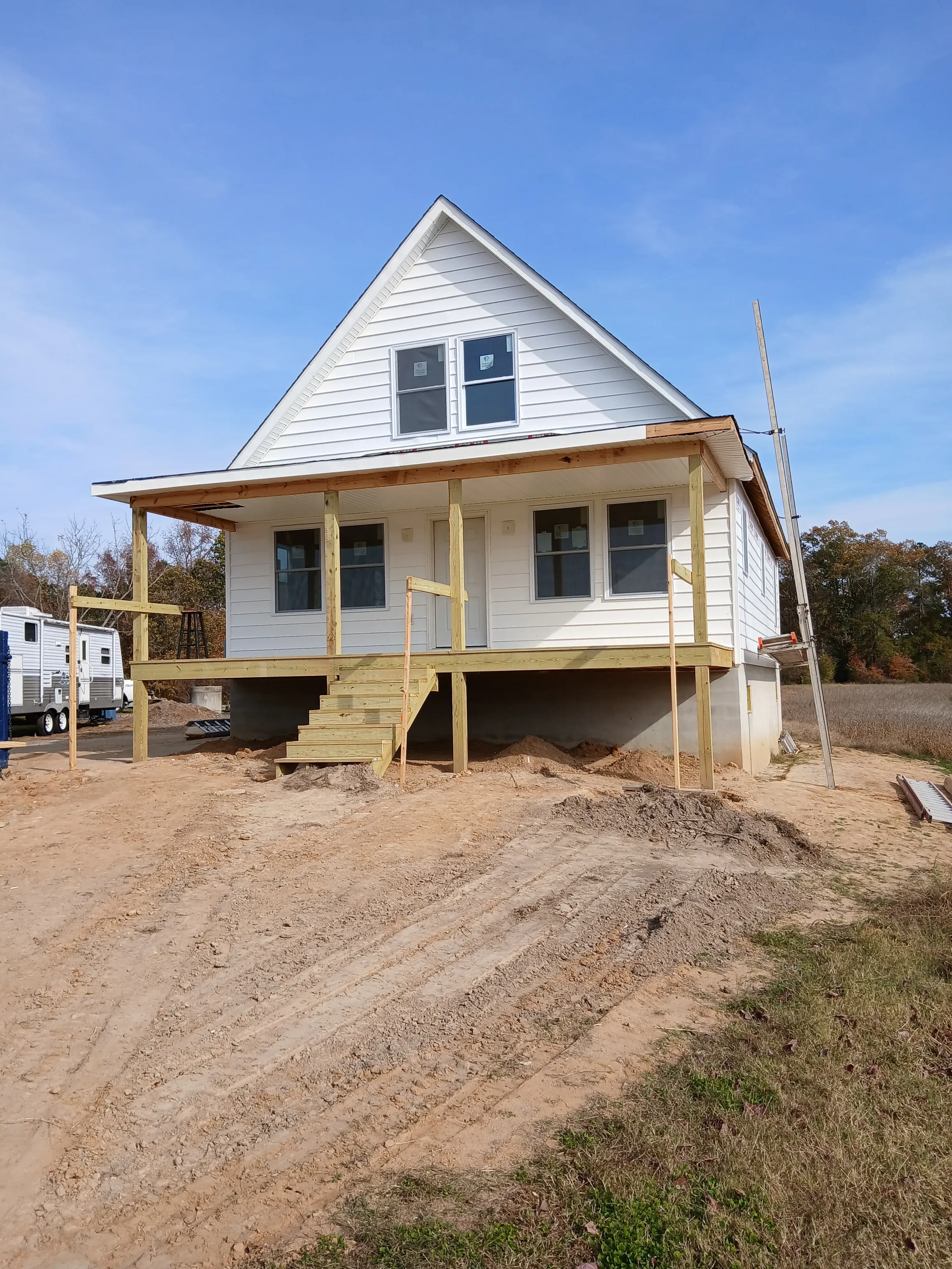 Metal standing-seam roof and vertical siding on residential addition with deck framing