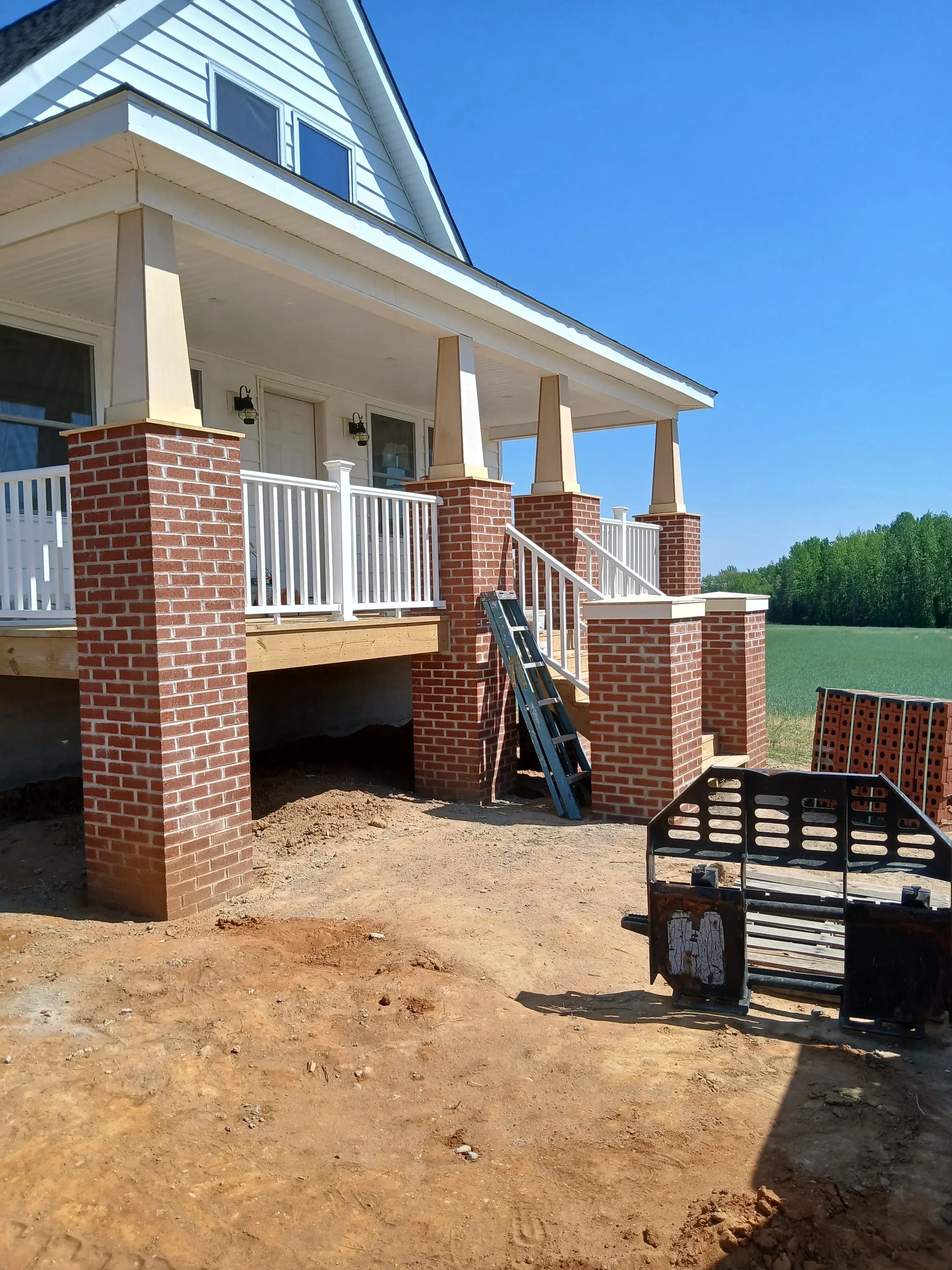 New red brick chimney with metal flashing and white trim on residential home