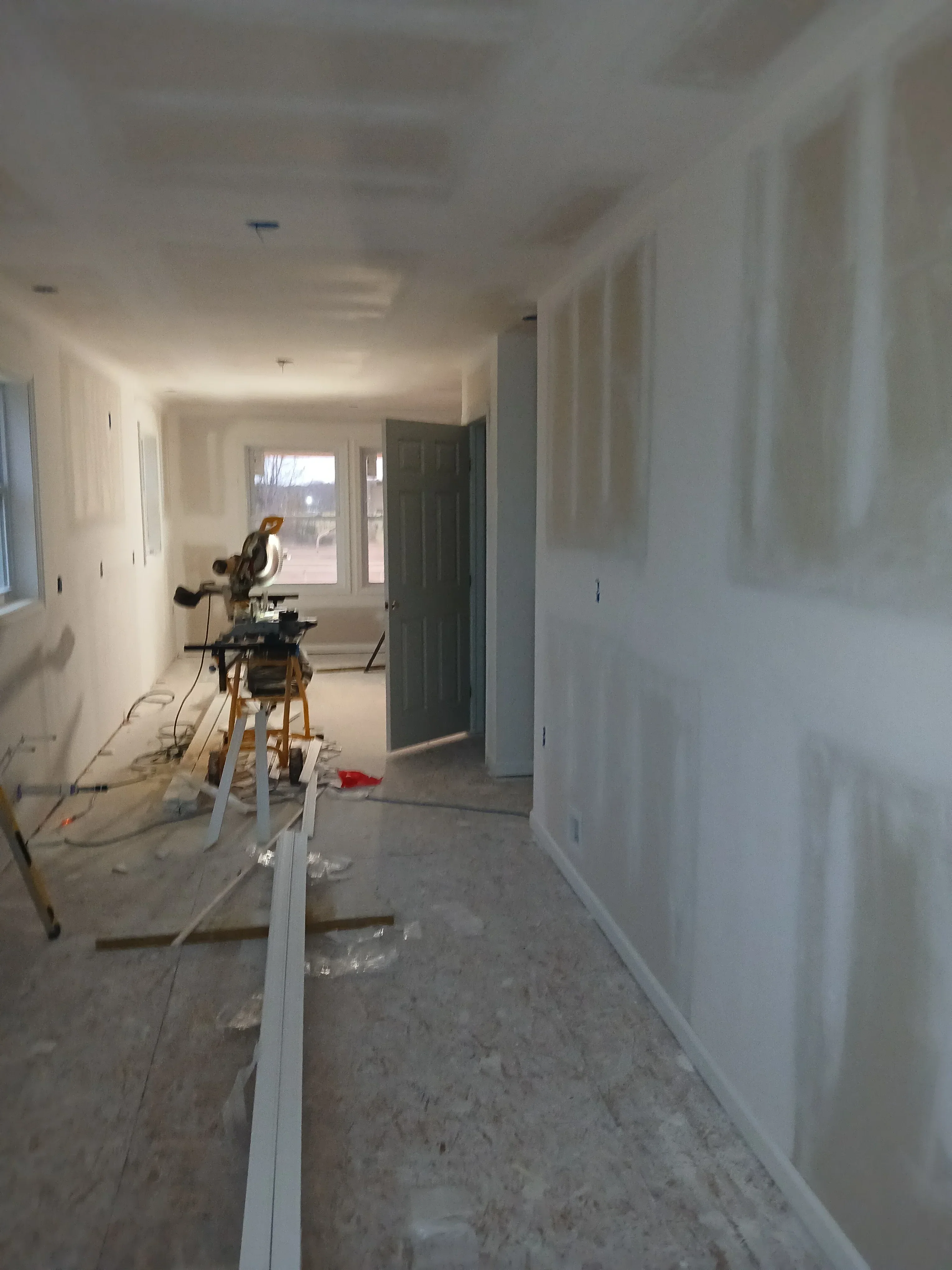 Drywall ceiling and walls with recessed lighting rough-in, finished joint compound in kitchen space