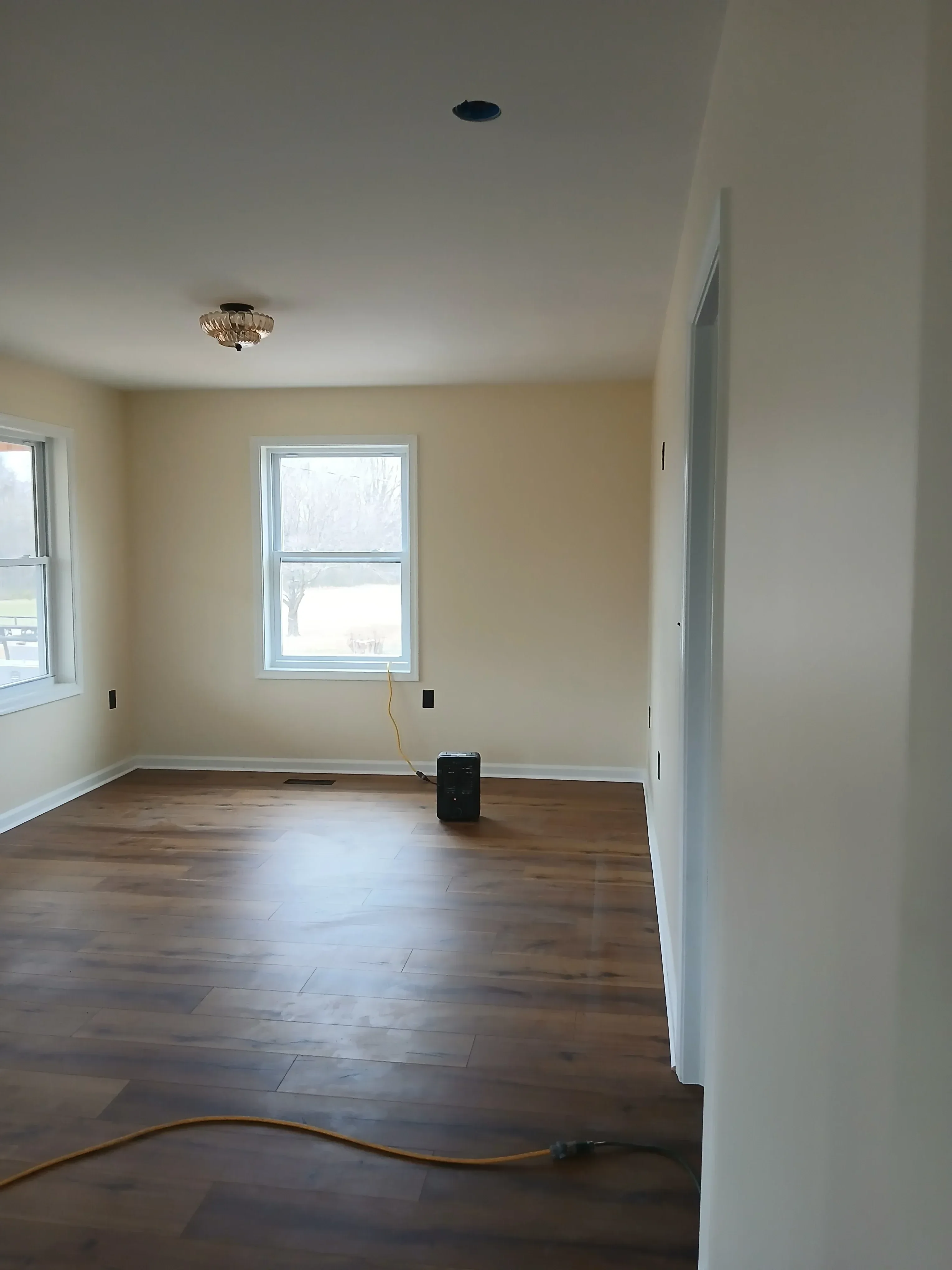 Drywall finishing, recessed lighting, and electrical rough-in in interior room renovation