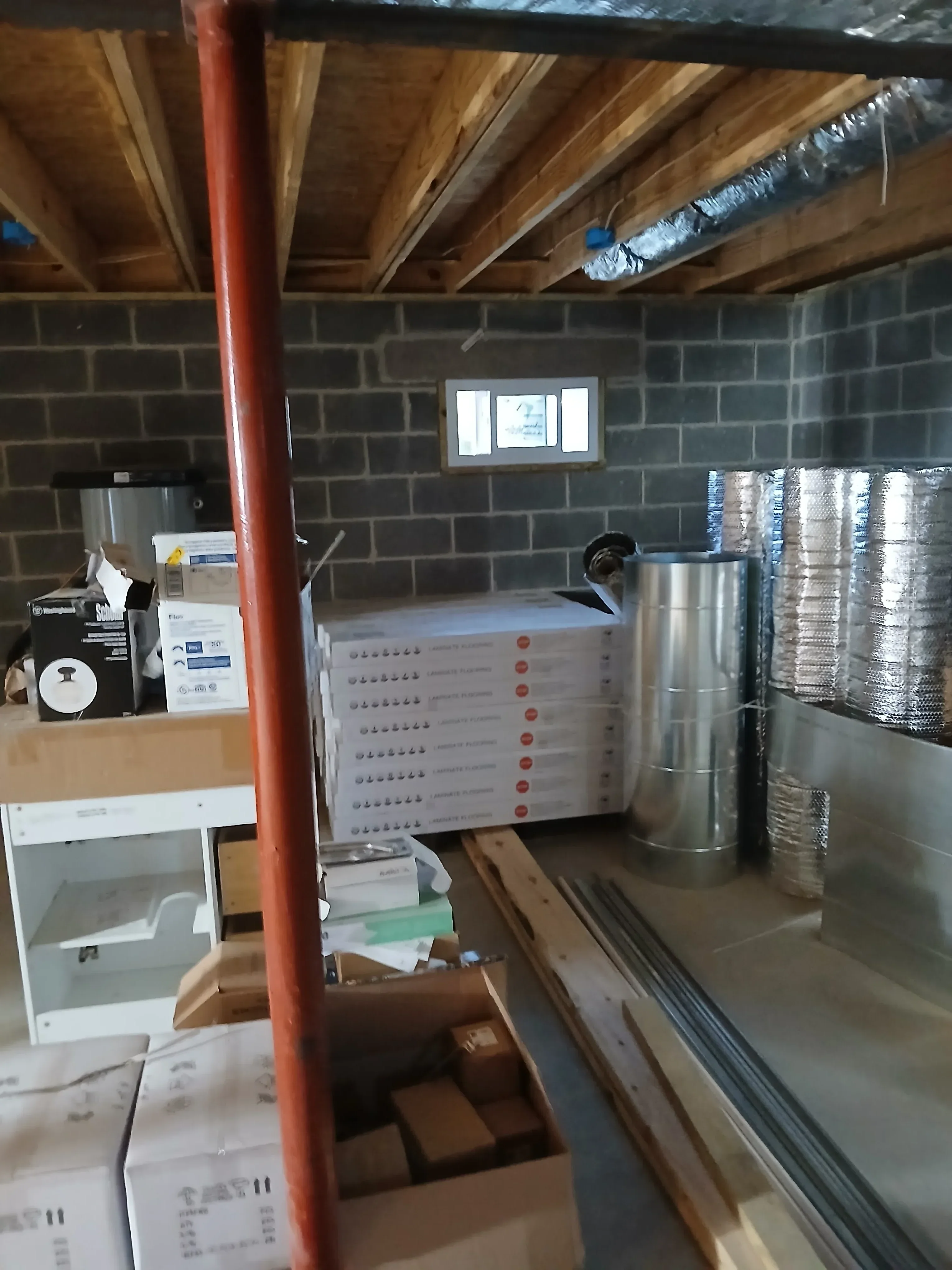 Bathroom under renovation showing gray subway tile walls, metal ductwork, recessed lighting, and framing work