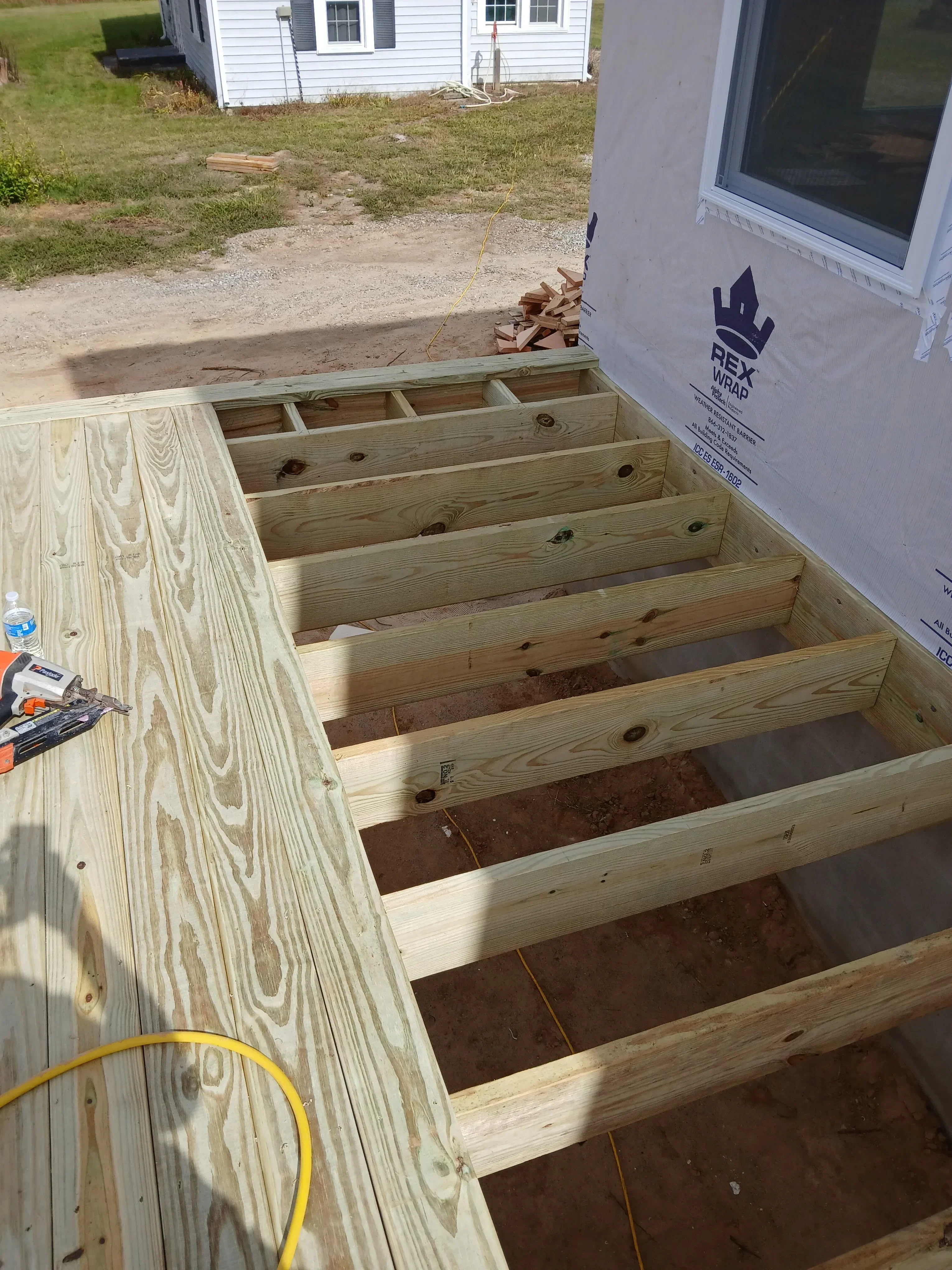 Wooden wall framing and OSB roof deck sheathing during construction phase